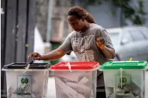  ?? ?? A woman casts her vote at a polling station in Lagos, Nigeria Saturday, Feb. 25, 2023. Voters in Africa’s most populous nation are heading to the polls Saturday to choose a new president, following the second and final term of incumbent Muhammadu Buhari. (AP Photo/Ben Curtis)