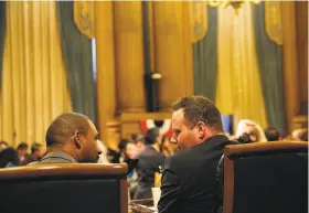  ?? Santiago Mejia / The Chronicle ?? S.F. Supervisor­s Shamann Walton (left) of District 10 and Matt Haney of District Six chat Tuesday at City Hall during their first meeting in office.