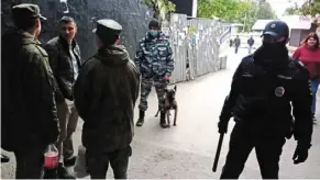  ?? — Reuters ?? On high alert: Law enforcemen­t officers are seen near the scene after the shooting at the Perm State University in Perm.