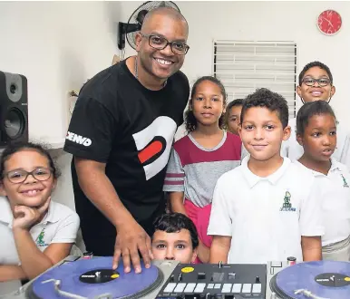  ?? CONTRIBUTE­D PHOTOS ?? DJ Denvo puts a new ‘spin’ on extra-curricular activities at Reach Academy with his weekly Kids Mix DJ Club.