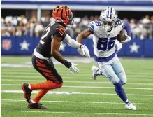  ?? RON JENKINS / AP ?? Cowboys wide receiver Ceedee Lamb (right) looks for yardage after a catch as Bengals cornerback Chidobe Awuzie closes in on him during a game in September. Awuzie missed Cincinnati’s final nine games and playoff run after suffering a knee injury.