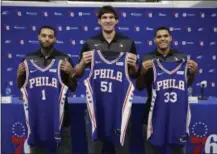  ?? MATT ROURKE — THE ASSOCIATED PRESS ?? Newly acquired Sixers, from left to right, Mike Scott, Boban Marjanovic, and Tobias Harris, pose for pictures Thursday during a news conference at the team’s practice facility in Camden, N.J.