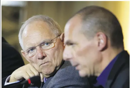  ?? Krisztian Bocsi / Bloomberg news ?? Wolfgang Schaeuble, Germany’s finance minister, left, looks toward Yanis Varoufakis, Greece’s finance minister, during a news conference at the Chanceller­y in Berlin on Thursday. The meeting comes hours after Greece
lost a critical funding artery when...