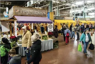  ?? THE ASSOCIATED PRESS ?? Visitors walk amongst various displays during the at the 2020Farm Show in Harrisburg.