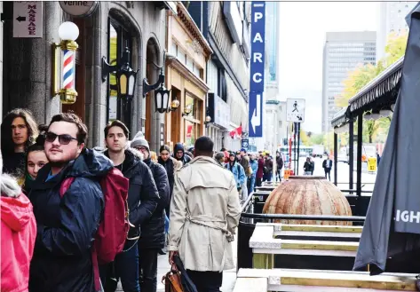  ?? MARTIN OUELLET-DIOTTE/AFP/GETTY IMAGES ?? People wait in line to enter a cannabis store in Montreal on Oct. 17, the day recreation­al pot became legal in Canada. Quebec’s cannabis retailer says it will close all 12 of its stores from Monday to Wednesday this week due to “chronic shortages of product.”