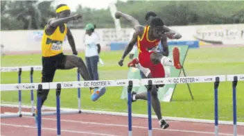  ?? (Photo: Paul Reid) ?? Cornwall College’s Tedre Butt (centre) leaps over the final hurdle in his section of the Class 2 boys’ 110m hurdles at the Milo Western Relays that were held at GC Foster in February.