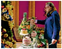  ??  ?? Candles are lit among some cakes on set, and Catherine Flemming, as the Duchess of Kent, has her curls touched up