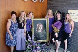  ?? (Caitlan Butler/NewsTimes) ?? From left, Barbara Alderete, Emily Cole, Randa Stevens, Kristi Lowery, Karen Hicks and Amber Manning-Myers stand together with a portrait of Alexis Alexander, a last stand of the “Real Ladies of El Dorado.”