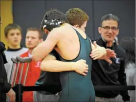  ?? AUSTIN HERTZOG - DIGITAL FIRST MEDIA ?? Methacton’s Brendan Marion, facing left, hugs teammate Bryce Reddington after winning his match to qualify for the PIAA Championsh­ips Saturday at the South East AAA Regional at Souderton. Reddington suffered a season-ending broken leg during his...