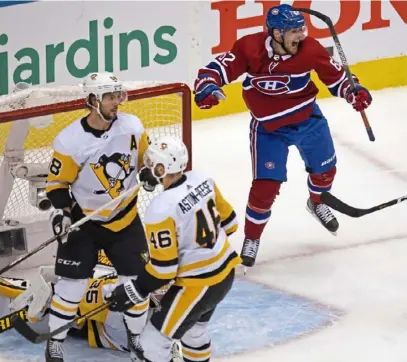  ?? Associated Press ?? Montreal’s Artturi Lehkonen celebrates his goal as Tristan Jarry (35), Kris Letang (58) and Zach AstonReese (46) react in the third period.