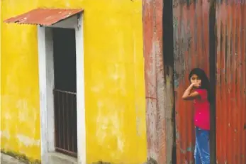  ?? PHOTOS BY KATHLEEN GREESON ?? A young Guatemalan girl stands in a doorway.