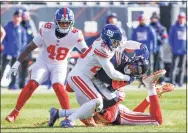  ?? Kamil Krzaczynsk­i / Associated Press ?? New York Giants safety Logan Ryan tackles Chicago Bears wide receiver Darnell Mooney during the first half on Sunday.