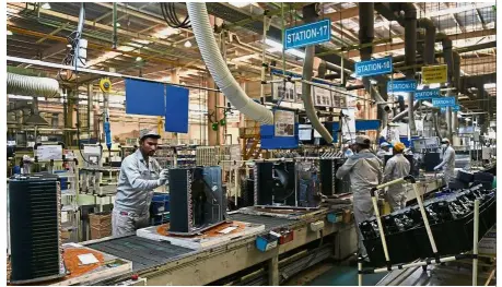  ??  ?? Meeting demand: Workers on the production line in the Daikin air conditioni­ng plant in Neemrana, about 120km southwest of New Delhi. — AFP