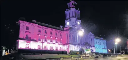  ??  ?? ●●Stockport Town Hall lit up in pink, purple and blue to celebrate Bi Visibility Day