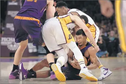  ?? Rick Loomis Los Angeles Times ?? SUNS GUARD Ronnie Price has the ball, and the unwanted attention of the Lakers’ Larry Nance Jr. and D’Angelo Russell, right.