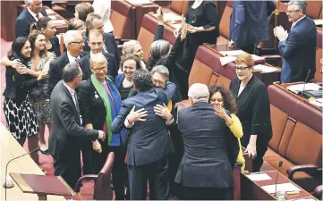  ??  ?? Senators are seen celebratin­g after the same-sex marriage bill passed the Senate in the Senate chamber at Parliament House in Canberra. — Reuters photo