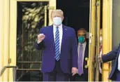  ?? EVAN VUCCI AP ?? President Donald Trump leaves the hospital after receiving experiment­al treatments for COVID-19.