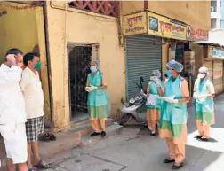  ??  ?? HEALTH WORKERS and nurses of Thane Municipal Corporatio­n surveying citizens for any symptoms of COVID-19, at Pachpakhad­i in Thane, Maharashtr­a.