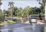  ?? THOMAS CORDY / THE PALM BEACH POST ?? High tides caused flooding Monday on Flagler Drive north of Southern Boulevard. Some drivers turned around when faced with higher water.