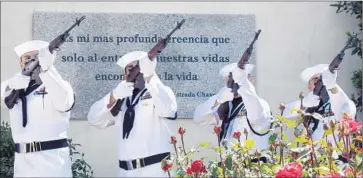  ?? Photograph­s by Scott Smith Associated Press ?? OFFICERS PERFORM a rif le salute in honor of the late labor activist Cesar Chavez, who joined the Navy in 1946 and served in the Western Pacific after World War II as a seaman. He returned from service in 1948.