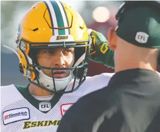  ?? BRENDAN MILLER ?? Eskimos quarterbac­k Trevor Harris chats with coaches during Saturday’s 24-18 loss to the Stampeders. Harris has thrown for 2,304 yards and 10 touchdowns in just seven games with his new team.