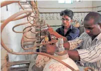  ?? AFP ?? Workers examine oxygen cylinders at the Baba Raghav Das Hospital in Gorakhpur on Saturday. —