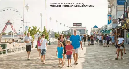  ?? ?? People stroll the boardwalk in Ocean City.
RACHEL SMITH PHOTOGRAPH­Y/OCEAN CITY TOURISM