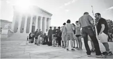  ?? JIM LO SCALZO, EPA ?? People gather Monday outside the Supreme Court, where the justices ruled on President Trump’s travel restrictio­ns.