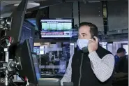  ?? NICOLE PEREIRA — NYSE VIA AP ?? A trader at the New York Stock Exchange works at his terminal Tuesday.