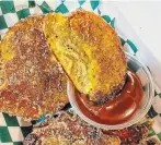  ??  ?? Fried plantain churros tossed in cinnamon sugar are served with dulce de leche dip.