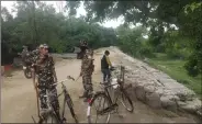  ??  ?? Sashastra Seema Bal personnel patrolling the embankment of the Lal Bakiya river.