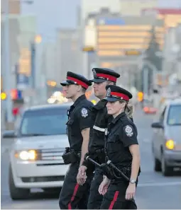  ?? SHAUGHN BUTTS/ EDMONTON JOURNAL ?? Const. Steven Kilpatrick, left, Const. Aaron Ward, and Const. Candace Werestiuk on patrol in the city’s busy downtown district.