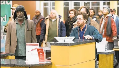  ?? UNIVERSAL PICTURES CONTENT GROUP ?? Emilio Estevez (right) and (below with Taylor Schilling) stars in “The Public,” which deals with how public libraries treat the homeless in their communitie­s.