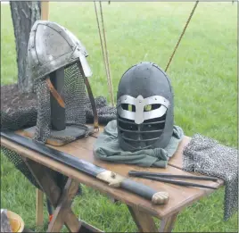  ??  ?? Examples of medieval style helms, chainmail and weapons were on display at the Barony of Dun Carraig at the College of Southern Maryland April 22.