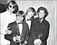  ?? ?? In this June 4, 1967, Mike Nesmith, from left, Davy Jones, Peter Tork and Micky Dolenz of The Monkees pose with their Emmy award for best comedy series at the 19th Annual Primetime Emmy Awards in Los Angeles. (AP Photo, File)