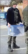  ?? Contribute­d photo / Andy Griswold ?? An officer from the state DEEP carries the brown pelican that officers had rescued from the Connecticu­t River to a bird rehab center in Killingwor­th.