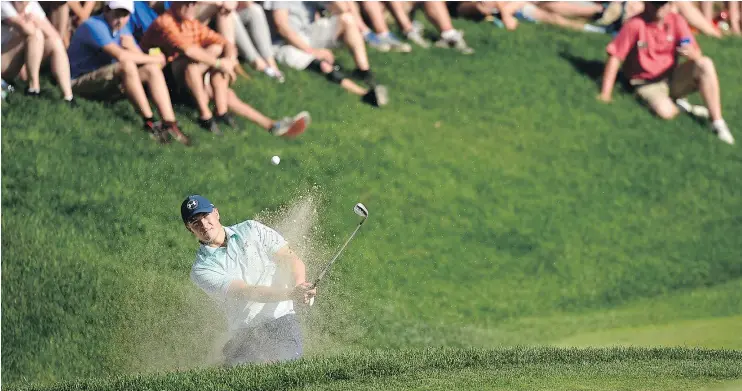  ?? — AP ?? Jordan Spieth hits from the bunker on the 15th hole on Saturday at the Travelers Championsh­ip. His chip landed inches from the hole for an eventual birdie.