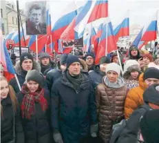  ?? — Reuters ?? Russian opposition leader Alexei Navalny (C) attends a rally, which marks the third anniversar­y of opposition figure Boris Nemtsov’s death, in Moscow on Sunday.