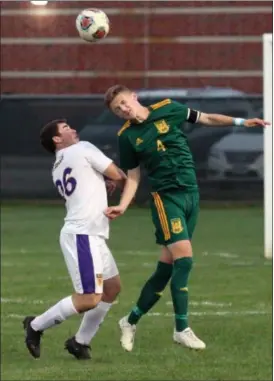  ?? RANDY MEYERS — THE MORNING JOURNAL ?? Ben Biedenbach of Amherst heads the ball over Nick Minotti of Avon during the first half on Oct. 3.