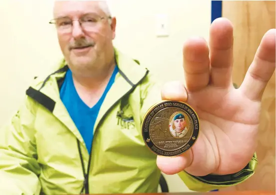  ?? ERIC BOURQUE ?? Capt. Gary Hudson, commanding officer of 110 Royal Canadian Army Cadet Corps in Yarmouth, holds the commemorat­ive coin that bears an image of Sgt. Kirk Taylor, who was killed in Afghanista­n a decade ago. The coin’s other side recognizes the 115th anniversar­y of the 110 army cadet corps.