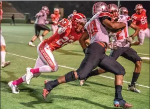  ?? NEWS-SENTINEL PHOTOS BY SHUMESA MOHSIN ?? Above: Jose Fonseca (22) lunges at Lincoln's Kenyon Nelson (10), in an effort to tackle him and stop his run at the Grape Bowl on Friday. Below: Angelo Zazzarino (3) charges through the clutches of Lincoln defender Ignacio Gonzalez (33) with the help of teammate Korbin Mason (83).