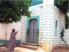  ??  ?? The Mosque which was built in 1351. Pointing at it is Alhaji Muhammed Salman, the emir’s clerk and palace tour guide