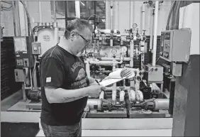  ?? SEAN D. ELLIOT/THE DAY ?? Dave Piermattei, boiler plant work leader at the Coast Guard Academy, makes the hourly rounds to check the systems at the academy’s boiler plant Monday.