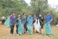  ??  ?? Hikers from One Hike Mountainee­ring Club participat­e in the annual National Mountain Clean-up Day at Mounts Palay-Palay/Mataas na Gulod Protected Landscape, site of the popular hiking destinatio­n, Mount Pico de Loro.