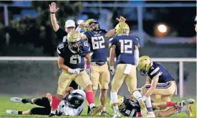  ??  ?? Kingfisher celebrates a sack on Perkins-Tryon's Austin Mages during a 38-31 win Thursday night. [SARAH PHIPPS/ THE OKLAHOMAN]