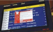  ??  ?? A window announcing the encryption of data and a demand for payment appears on an electronic timetable display at the railway station in the German city of Chemnitz on Friday.