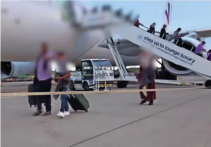  ??  ?? Refugees arrive at Birmingham Airport from Kabul – the airport is the main gateway to the UK from Afghanista­n