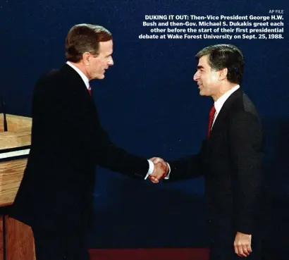  ?? AP FILE ?? DUKING IT OUT: Then-Vice President George H.W. Bush and then-Gov. Michael S. Dukakis greet each other before the start of their first presidenti­al debate at Wake Forest University on Sept. 25, 1988.