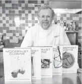  ?? STEPHEN CHERNIN THE ASSOCIATED PRESS FILE PHOTO ?? Nathan Myhrvold, author of “Modernist Cuisine: The Art and Science of Cooking,” poses with books from the work at the Institute for Culinary Education, in New York.