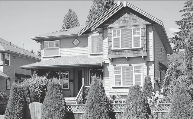  ??  ?? The 3,318 square- foot tri- level home at 566 West 21st St. in North Vancouver was built by Noort Homes in 2001. It features five bedrooms and a landscaped yard.